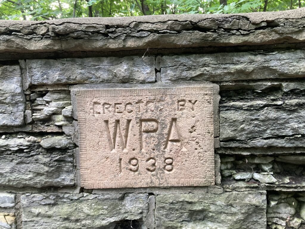 a stone wall with a plaque that reads, WPA 1938