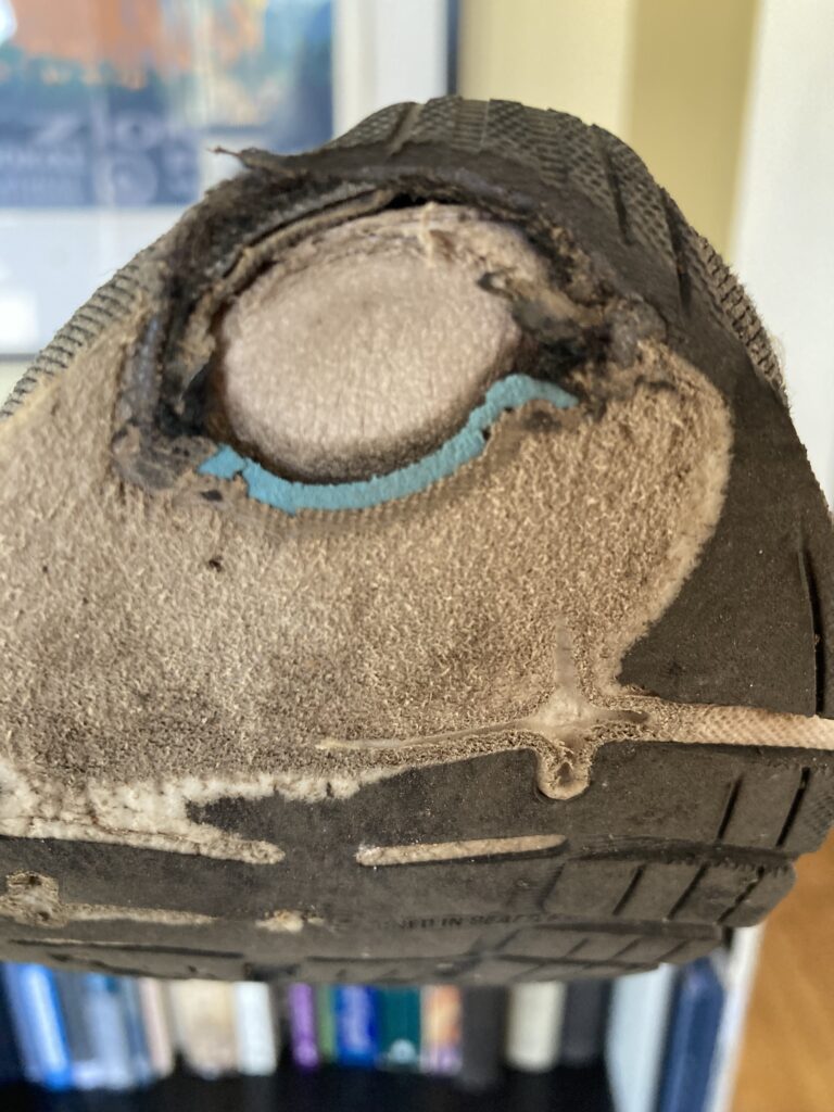 a close-up of the bottom of my running shoe with a white circle which is a hole that goes all the way through